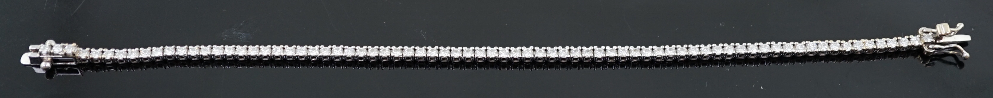 A modern 18ct white gold and diamond set line bracelet